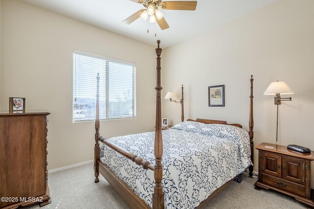 bedroom featuring light colored carpet and ceiling fan