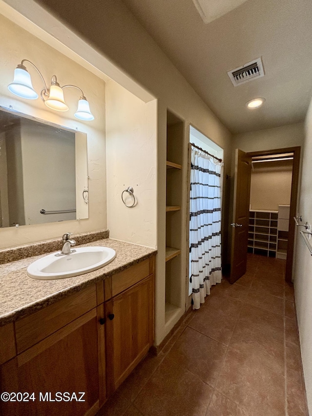 bathroom featuring a shower with shower curtain, vanity, and tile patterned floors