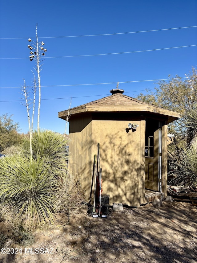 view of home's exterior with a shed