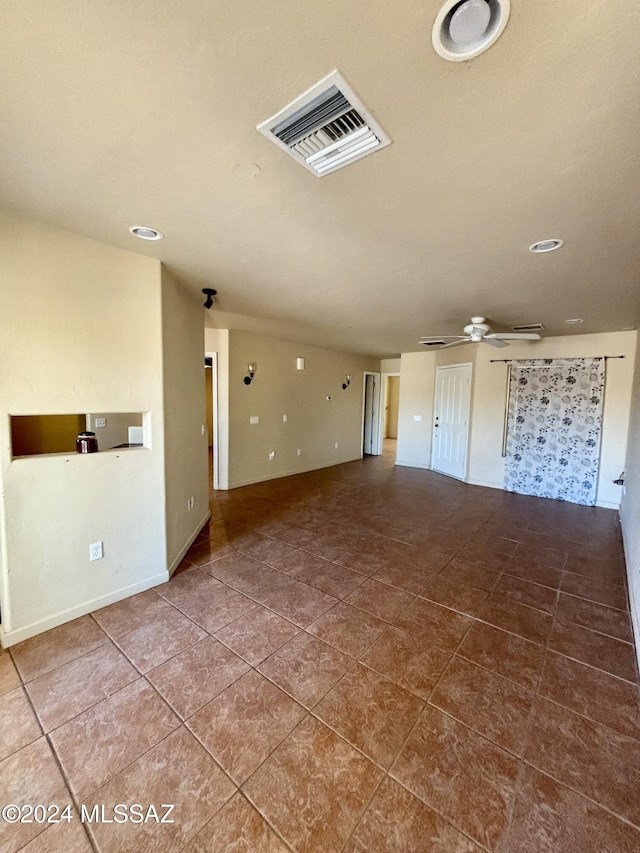 interior space with tile patterned floors and ceiling fan