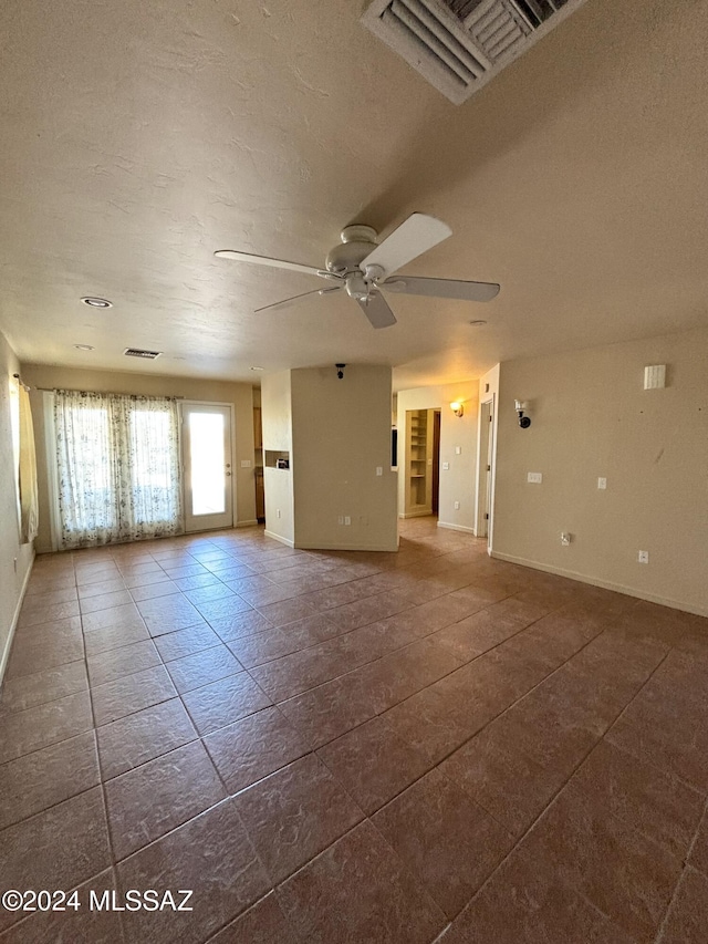 empty room featuring a textured ceiling and ceiling fan