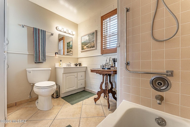 full bathroom featuring tile patterned floors, vanity, a textured ceiling, tiled shower / bath combo, and toilet