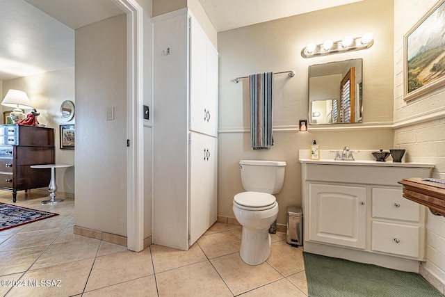 bathroom featuring tile patterned flooring, vanity, and toilet