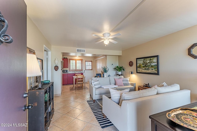 living room featuring light tile patterned floors and ceiling fan