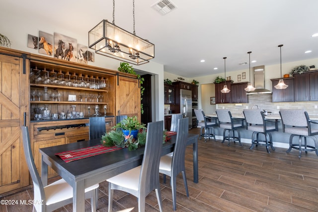 dining room featuring dark hardwood / wood-style floors and a notable chandelier