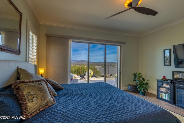 bedroom featuring ceiling fan, access to exterior, wood-type flooring, and multiple windows