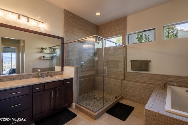 bathroom featuring tile patterned floors, vanity, and a healthy amount of sunlight