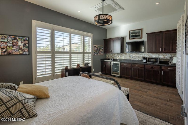 bedroom with dark hardwood / wood-style flooring and beverage cooler