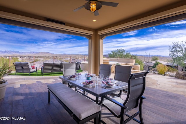 view of patio with a mountain view and ceiling fan