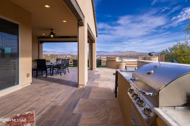 view of patio / terrace with grilling area, a mountain view, and area for grilling