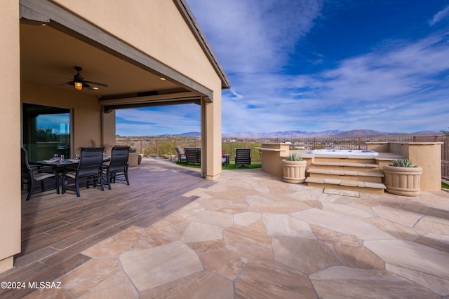 view of patio / terrace featuring a mountain view and ceiling fan