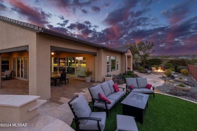 patio terrace at dusk featuring an outdoor hangout area