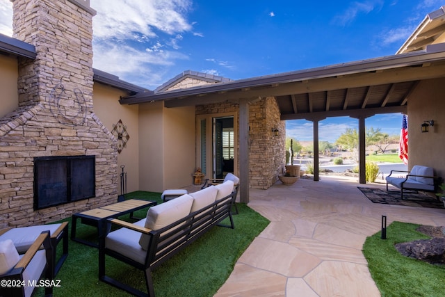 view of patio / terrace featuring an outdoor living space with a fireplace