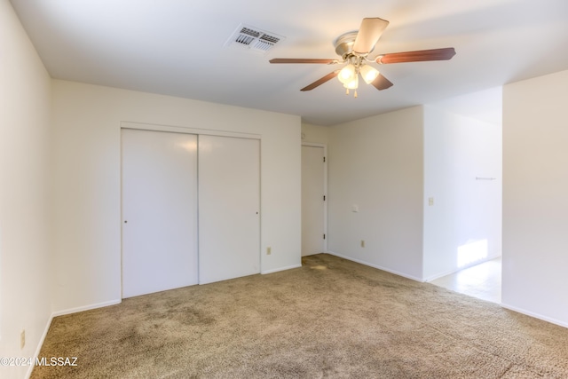 unfurnished bedroom featuring ceiling fan, carpet floors, and a closet