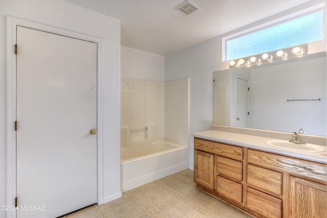 bathroom with shower / bathing tub combination and vanity