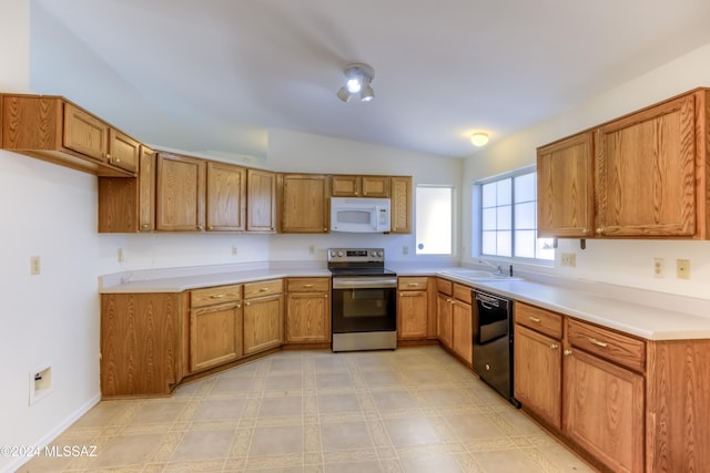 kitchen with dishwasher, stainless steel range with electric cooktop, lofted ceiling, and sink