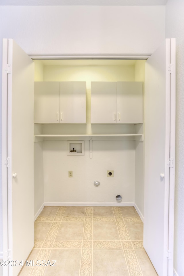 washroom with electric dryer hookup, cabinets, gas dryer hookup, hookup for a washing machine, and light tile patterned flooring