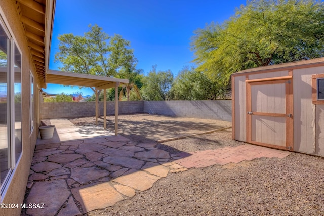 view of patio featuring a storage shed