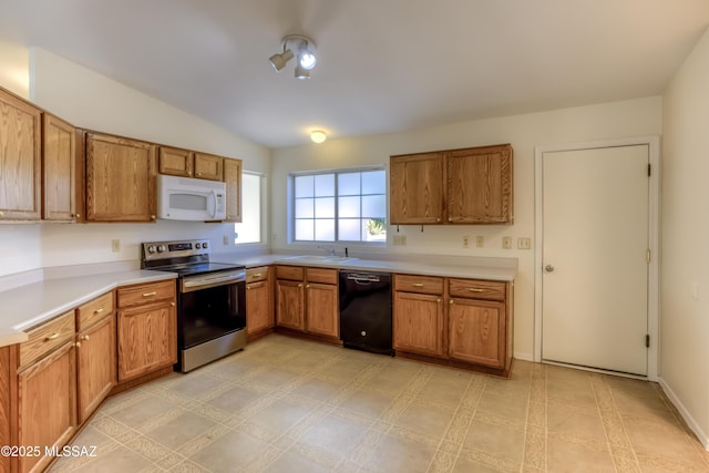 7850 S Solomon Ave, Tucson, AZ 85747 - kitchen with black dishwasher, electric stove, white microwave, a sink, and brown cabinets
