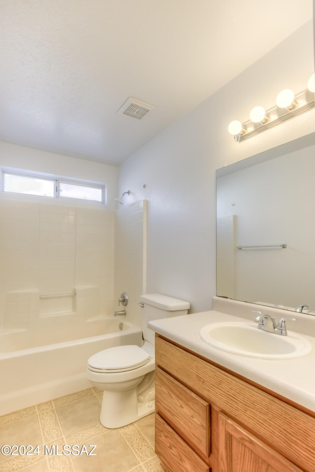 full bathroom featuring tile patterned flooring, vanity, toilet, and tiled shower / bath combo