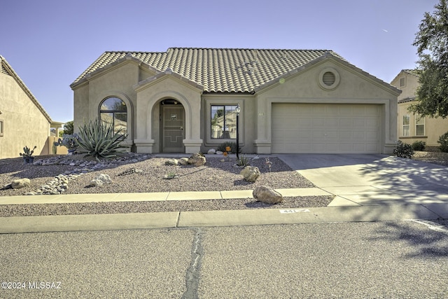 mediterranean / spanish house with a garage