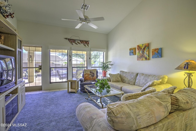 living room featuring ceiling fan, carpet floors, and high vaulted ceiling