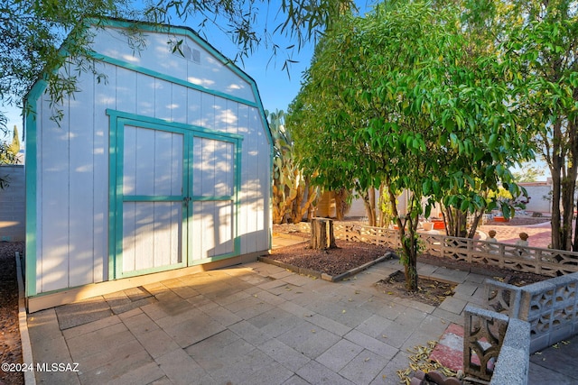 view of patio / terrace featuring a storage unit