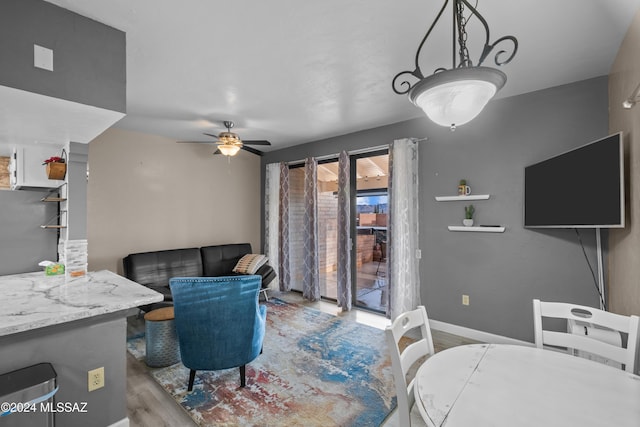 living room featuring light hardwood / wood-style floors and ceiling fan