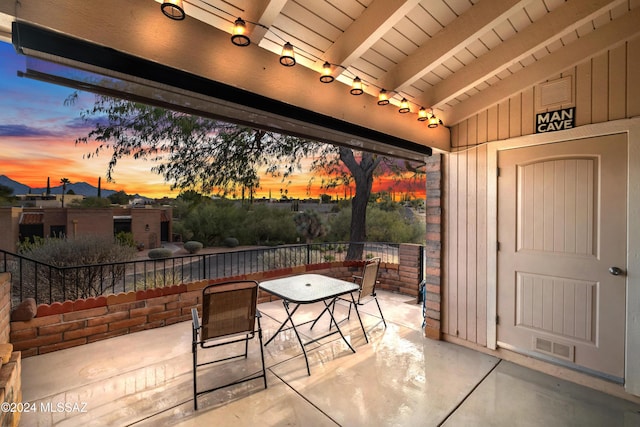 view of patio terrace at dusk