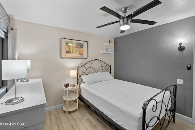 bedroom with ceiling fan and light hardwood / wood-style flooring