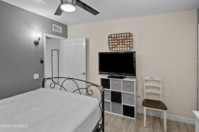 bedroom with ceiling fan and light hardwood / wood-style flooring