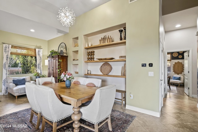 tiled dining room with a notable chandelier and built in shelves