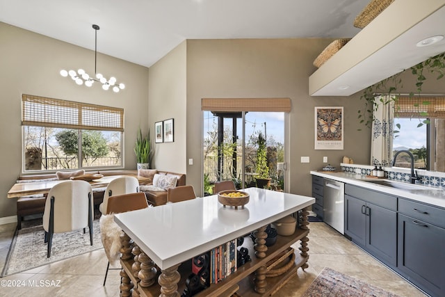 kitchen featuring dishwasher, a wealth of natural light, and hanging light fixtures