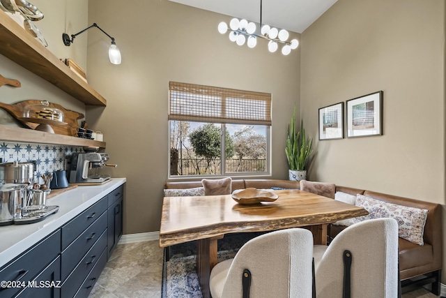 dining room with high vaulted ceiling and a notable chandelier