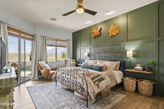 bedroom featuring wood-type flooring, access to outside, and ceiling fan