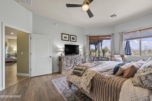 bedroom featuring access to outside, hardwood / wood-style flooring, and ceiling fan