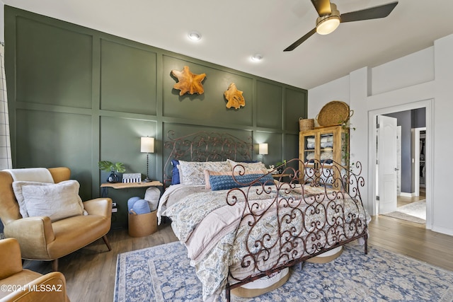 bedroom with dark hardwood / wood-style floors and ceiling fan