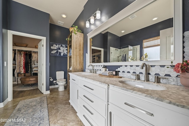 bathroom with vanity, lofted ceiling, toilet, walk in shower, and tasteful backsplash