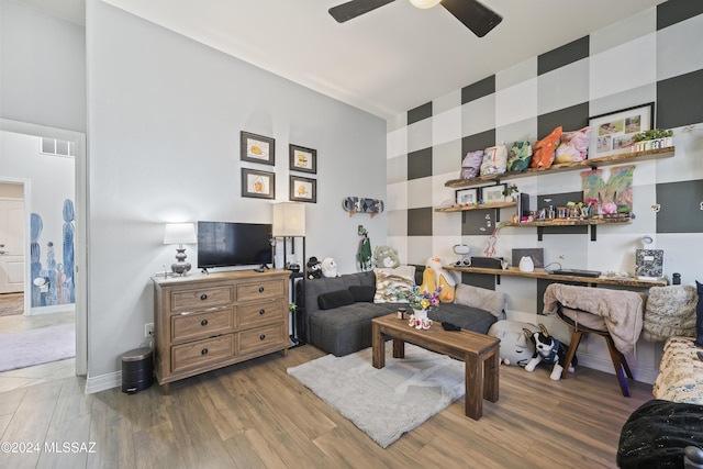 living room with ceiling fan and light hardwood / wood-style floors