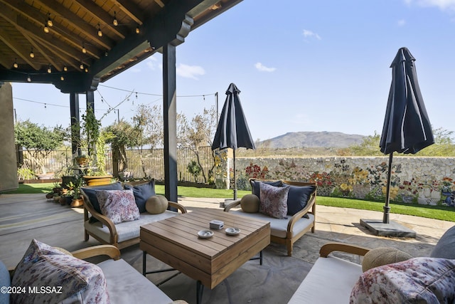 view of patio / terrace with an outdoor living space and a mountain view