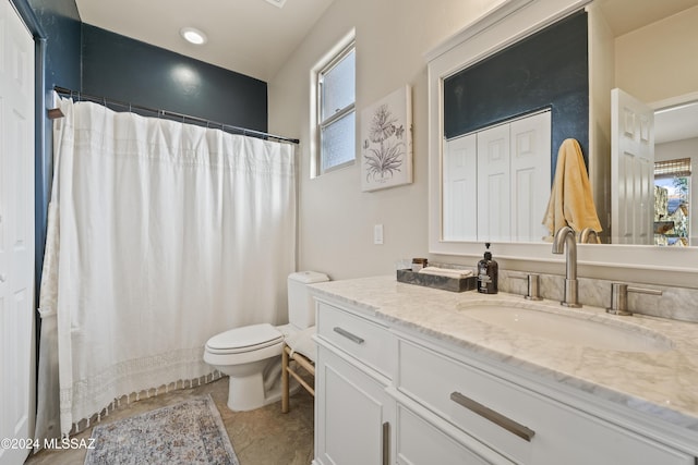 bathroom featuring tile patterned flooring, vanity, curtained shower, and toilet