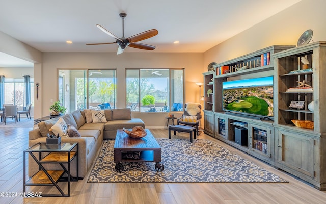 living room featuring ceiling fan and light hardwood / wood-style floors