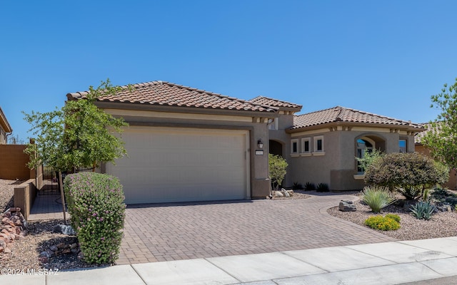 mediterranean / spanish-style house with a garage