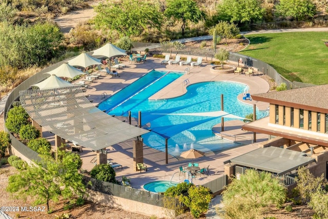 view of pool featuring a patio and a lawn