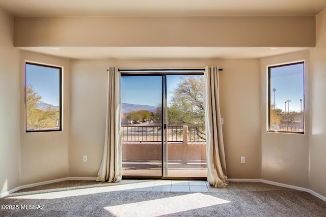 carpeted spare room with a mountain view