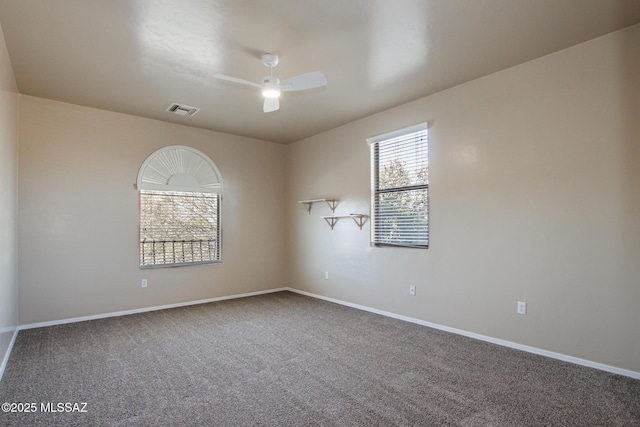 carpeted spare room with ceiling fan