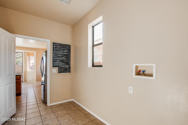 laundry room featuring light tile patterned flooring and hookup for a washing machine