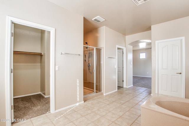 bathroom featuring tile patterned floors and shower with separate bathtub