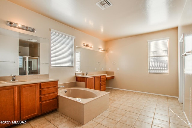 bathroom featuring tile patterned flooring, shower with separate bathtub, and vanity