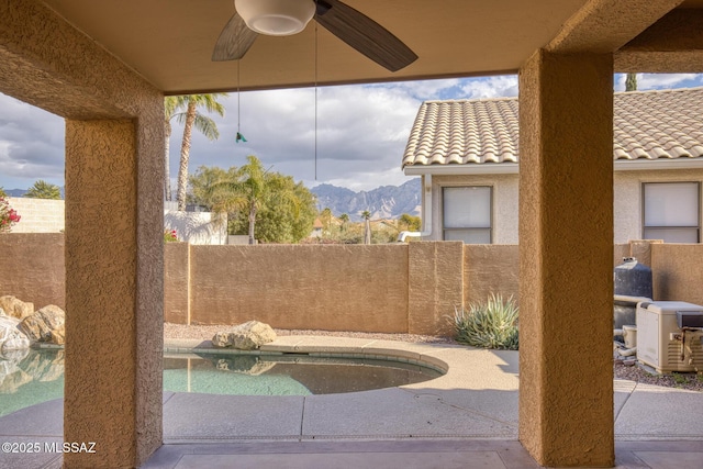 view of patio featuring a mountain view and ceiling fan